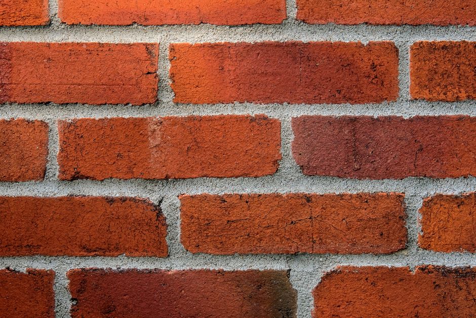 Detailed close-up of a red brick wall showing texture and mortar lines.